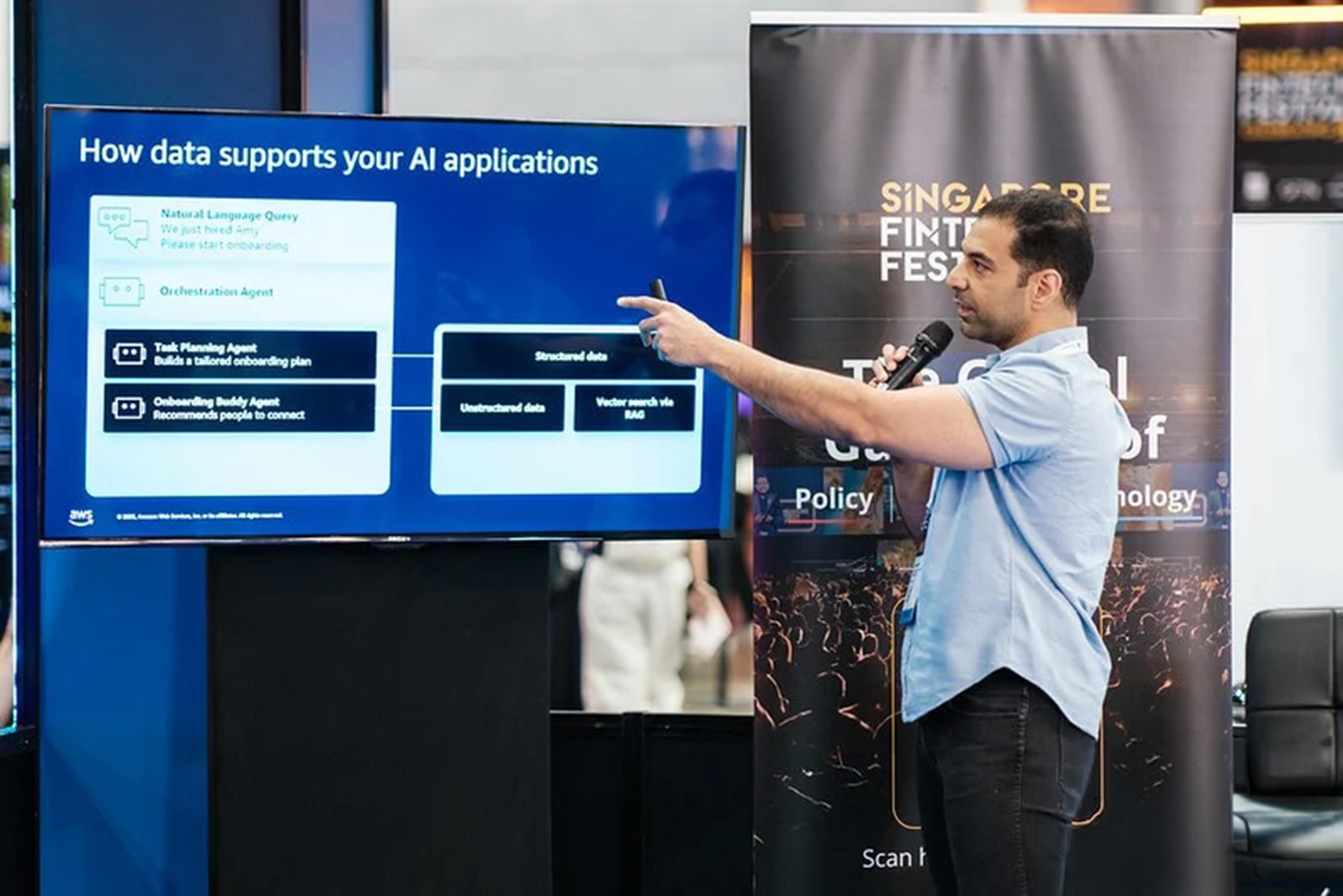 A speaker presenting a slide on data and AI applications at an Investor Hours masterclass