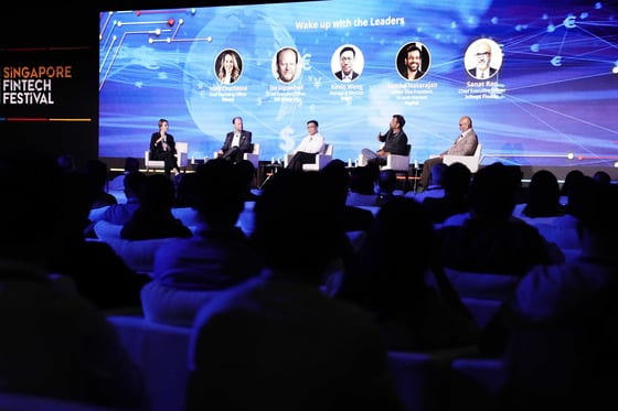 A panel on stage at Singapore FinTech Festival, the audience in front