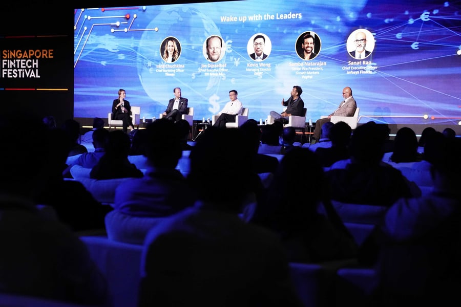 A panel on stage at Singapore FinTech Festival, the audience in front