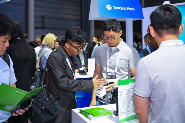 Delegates talking at the Tencent stand