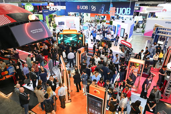 A busy exhibition aisle beneath the UOB stand