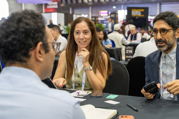 A smiling delegate in a one-to-one meeting at an SFF MeetUp table