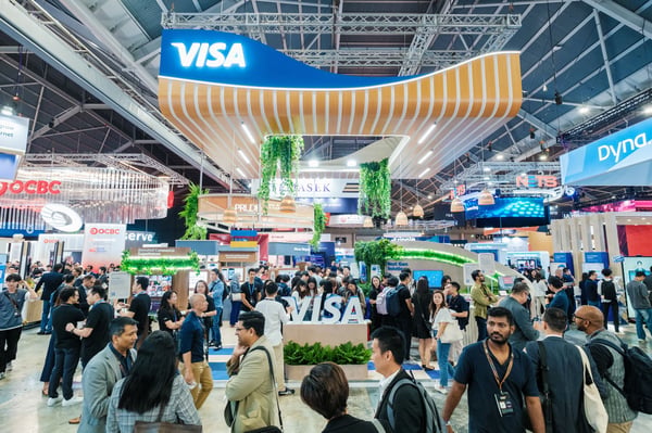 Crowds in the exhibition hall beneath the Visa stand